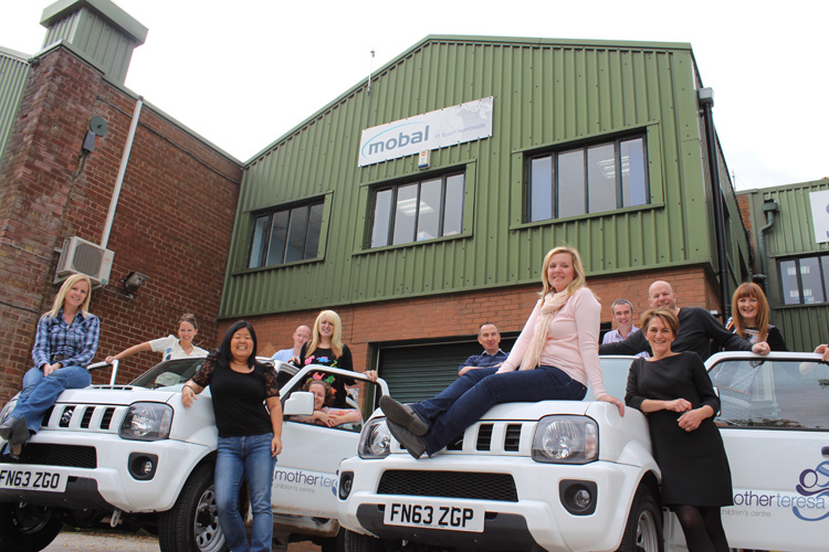 Mobal staff with the two new jeeps before being shipped to the Mother Teresa Children's Center.