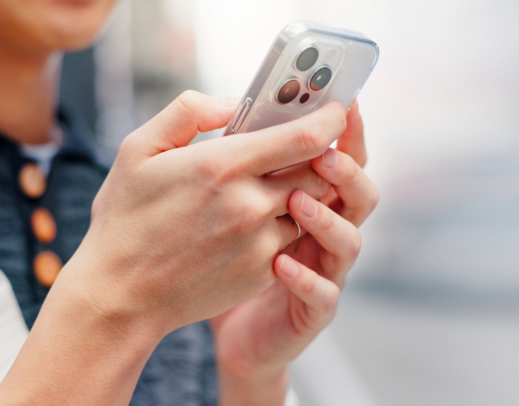A person holding their phone in Japan, using data.