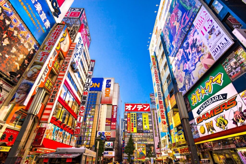 Colourful anime billboards and electronics shops lining a busy street in Akihabara, Tokyo’s main gaming and otaku shopping district.
