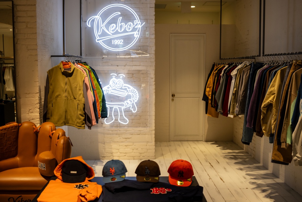 Interior of the Kebab streetwear clothing store in Tokyo, with jackets, caps and folded clothing on display.