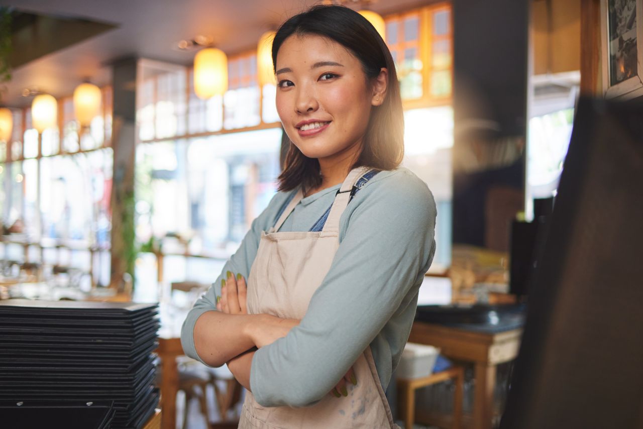 Café worker preparing drinks behind a counter in a Tokyo coffee shop